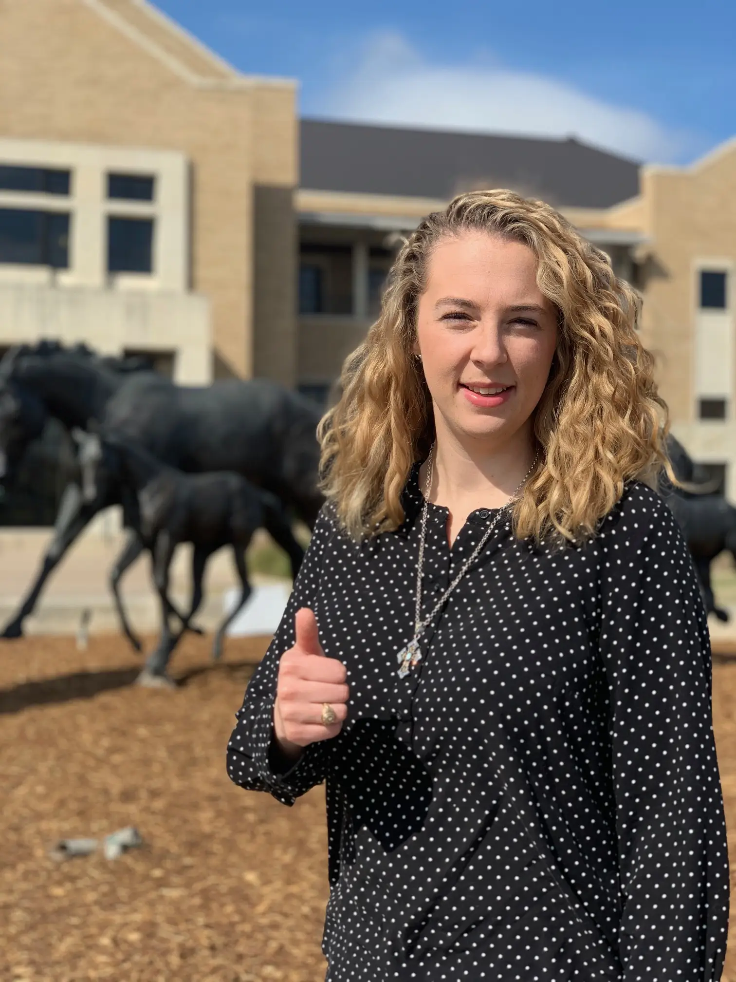Dr. Kendall Pittman thumbs up outdoors